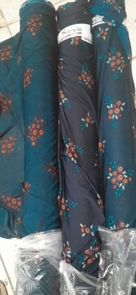 Rolls of teal and charcoal floral 9F fabric